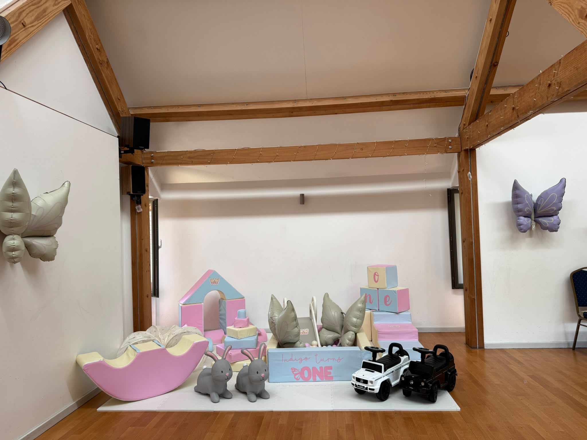 A pastel soft play setup styled for a first birthday