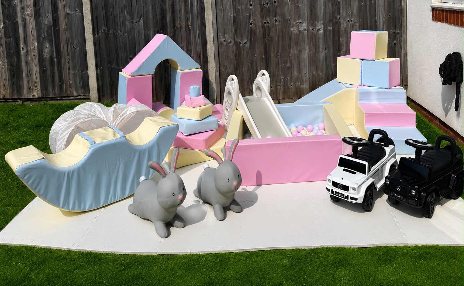 Outdoor pastel soft play setup with ball pit and slide